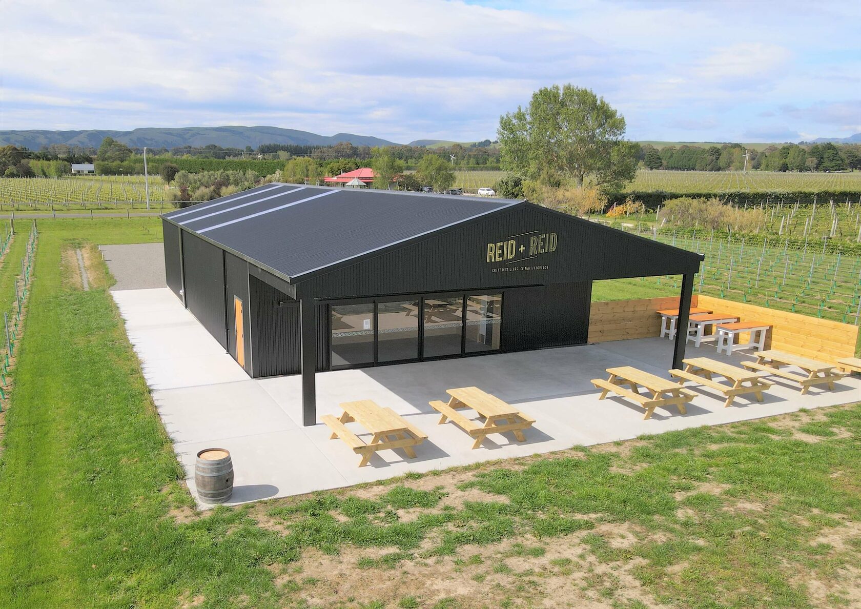 Modern black commercial shed in vineyard setting